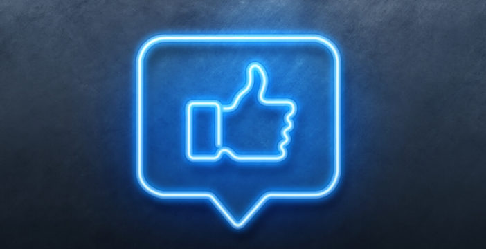 A neon sign shows a thumbs up