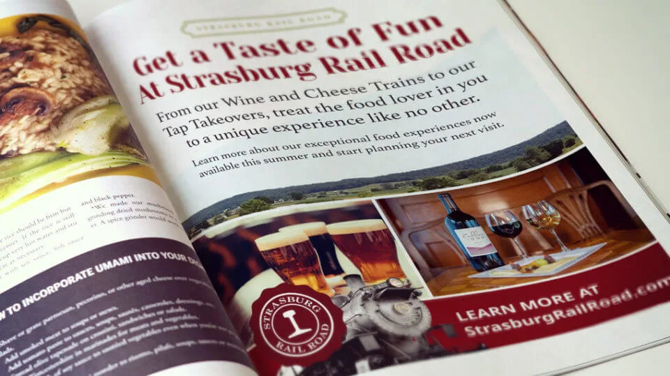 A close up of a strasburg railroad ad in a magazine.