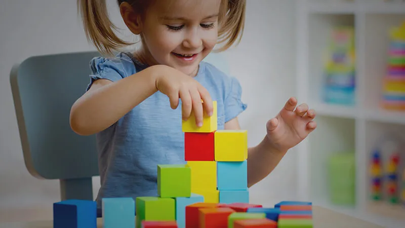 little girl playing with blocks
