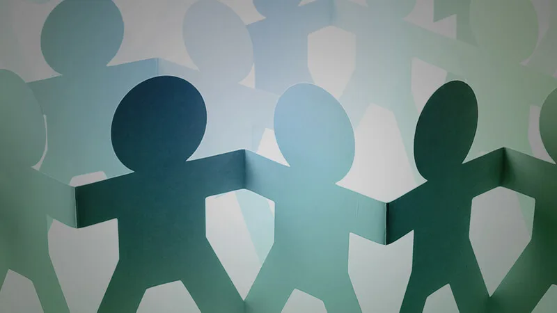 paper cutouts holding hands