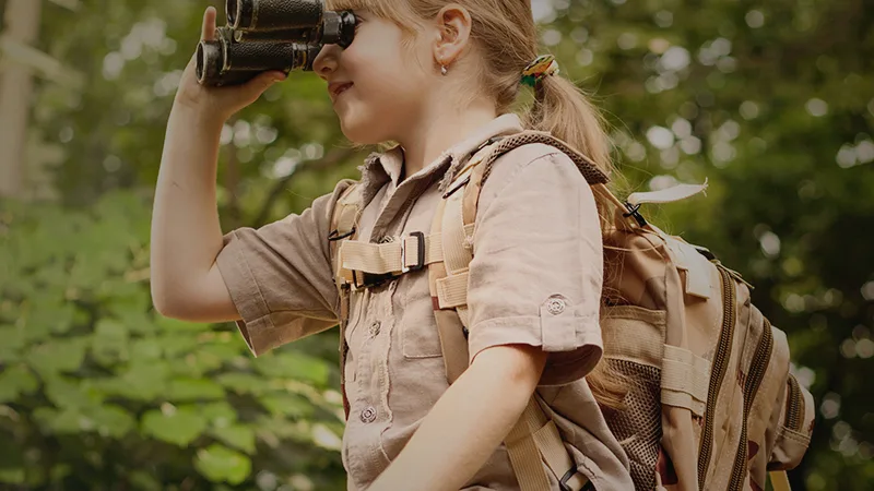 girl looking through binoculars
