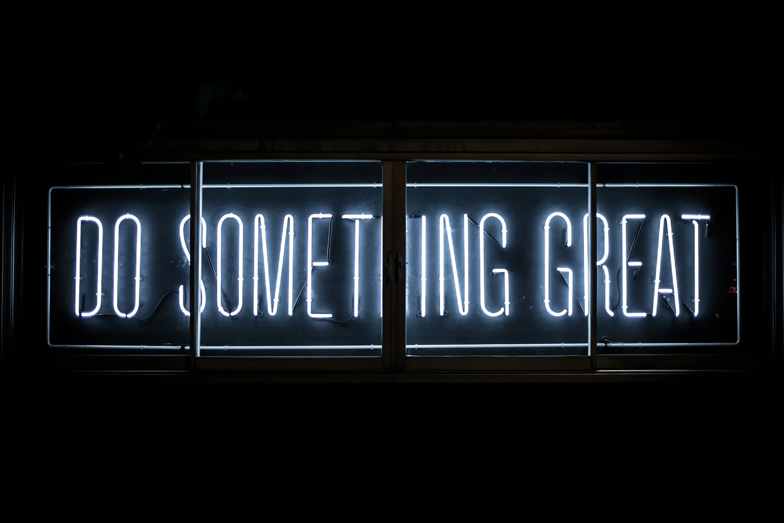 A neon sign that says do something great.