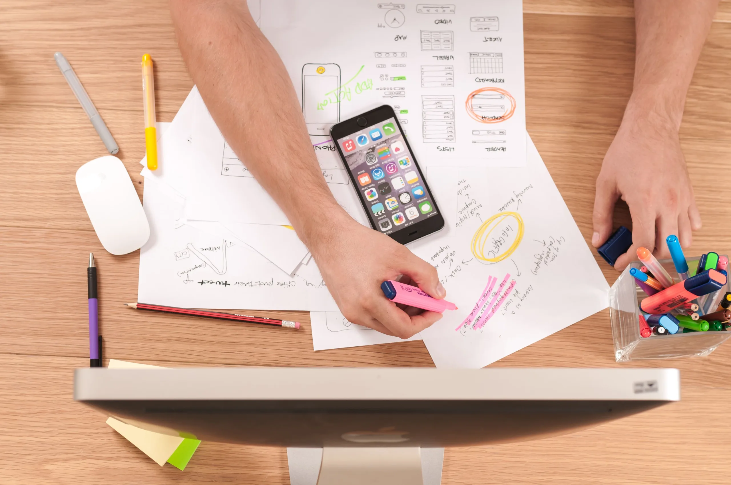 A marketer plans out his social plan on paper at his desk.