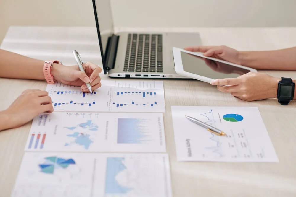 Two teammates work together to develop their non-profit marketing budget and marketing strategy.