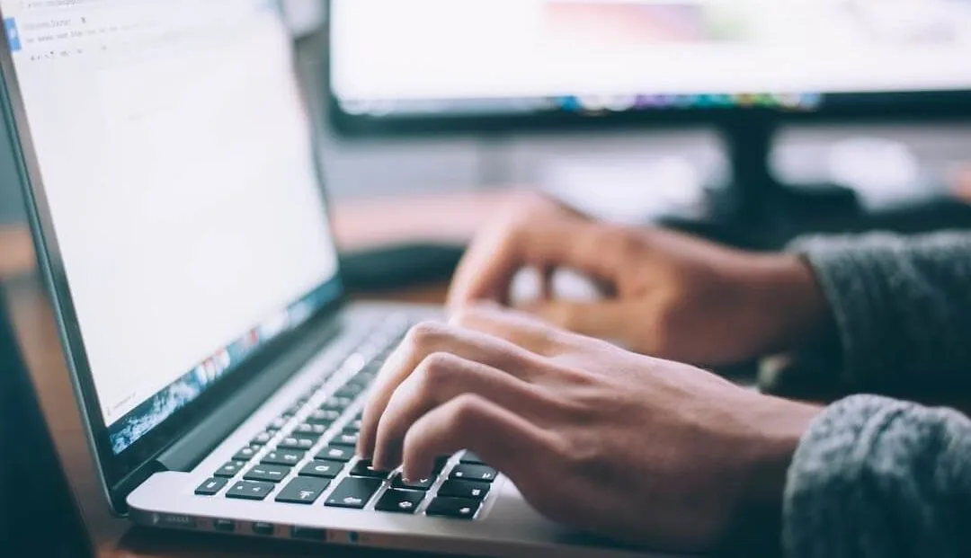 Person typing on laptop