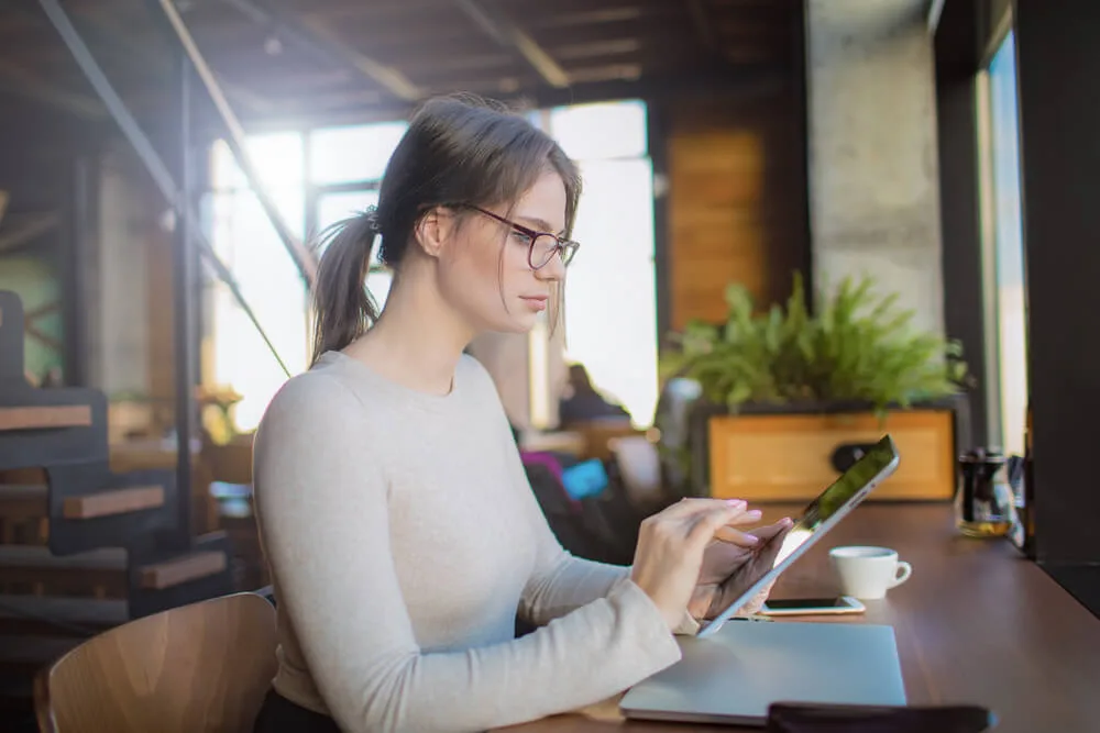 A woman checks her phone.