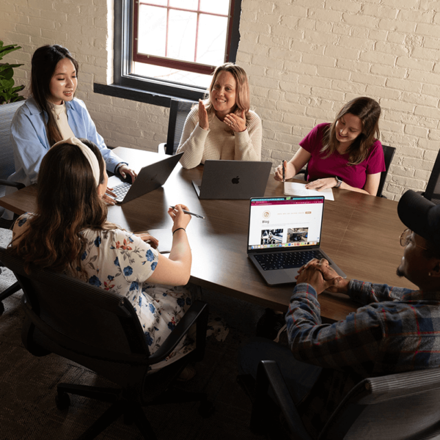 Tower Marketing employees strategizing digital marketing services for a client in a conference room