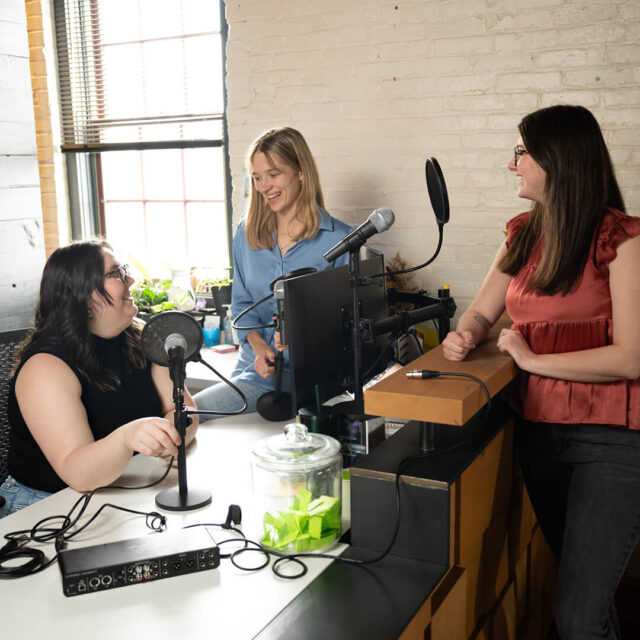 Tower After Hours podcast team discussing the latest podcast episode around a desk