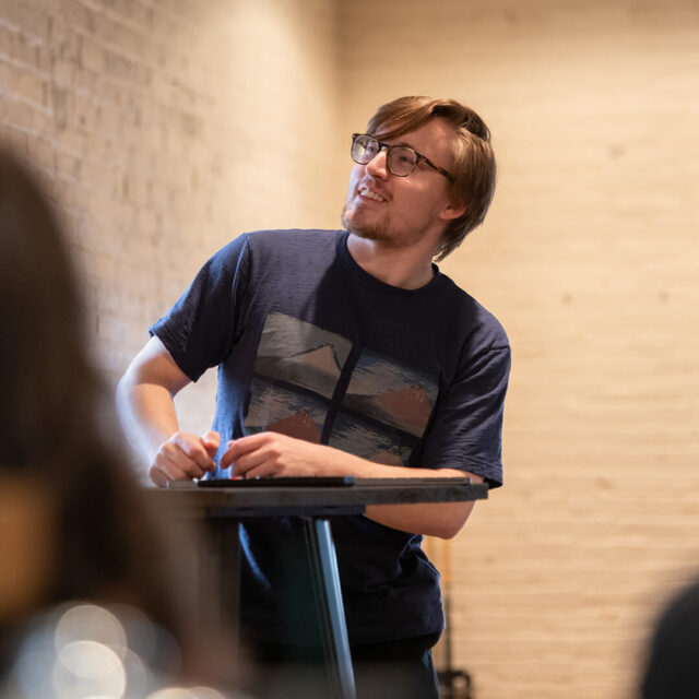 Tower Marketing employee presenting a detailed SEO presentation while standing at a podium