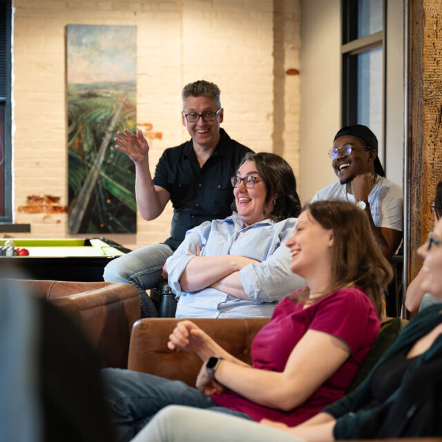 Tower Marketing employees laughing during a training session in the Tower Marketing office