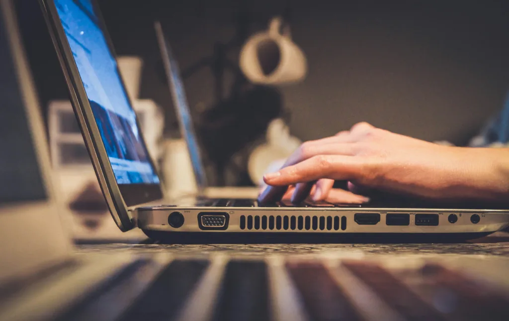 a person's hands on a laptop searching Google with unique keyword intent