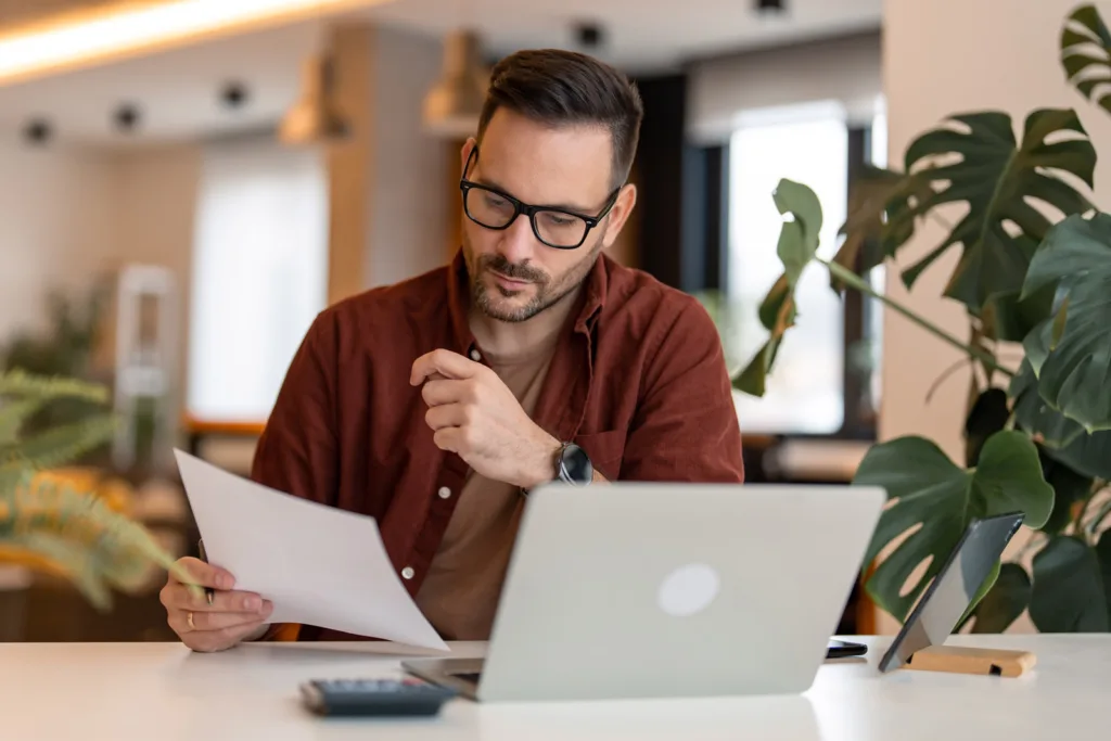 A man reviewing email requirements.