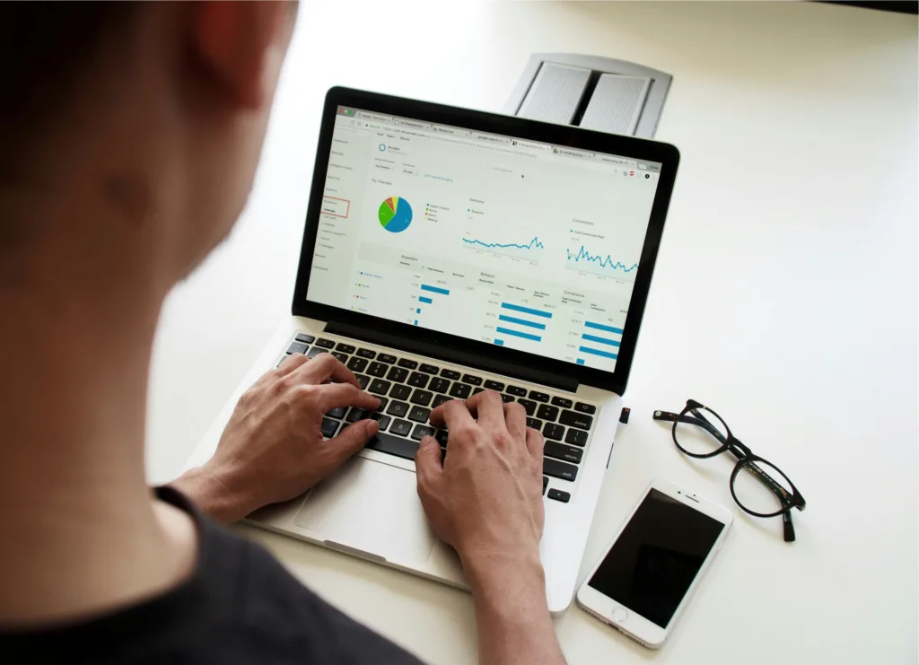 Person analyzing data on laptop through google analytics